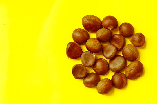 Chestnuts pattern on yellow background top view chestnut