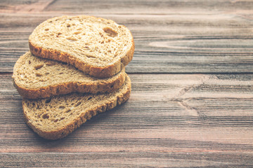 Slices of rye bread on a wooden background
