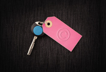 Modern key and label with copyright symbol. Concept image of protection of intellectual property, business security and safety.