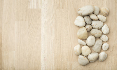 Stones on wooden background, concept of harmony and tranquility. Decoration with stone pebbles as natural design backdrop with copy space.