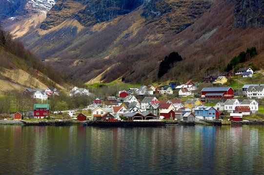 colorful Scandinavian houses reflected in water of Norwegian fjord in Norway

