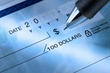 detail image of a ballpoint pen and a cheque.