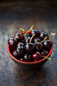 Cherries in a red bowl