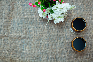 two glasses of red wine and flowers