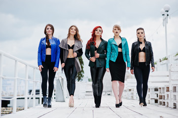 Group of sexy models girls in black bra and leather jackets on t