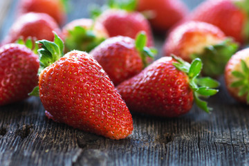 Fresh strawberries on old wooden background