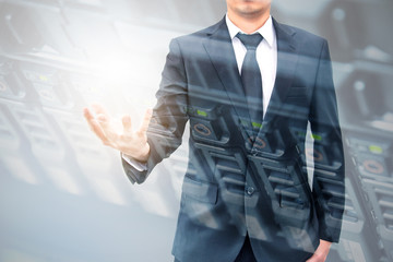 Double exposure of hand businessman and servers technology in datacenter with text copy space above empty hand