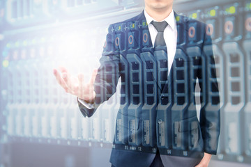 Double exposure of hand businessman and servers technology in datacenter with text copy space above empty hand
