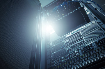 Bottom view of rack server against neon light in datacenter with