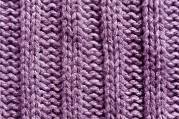 Abstract magenta knitting texture close-up.
