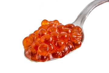 Red caviar in spoon on a white background. Gourmet food close up
