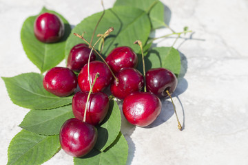 Ripe cherries on a light background