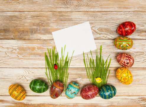 Blank, greeting easter card with easter eggs and green grass on