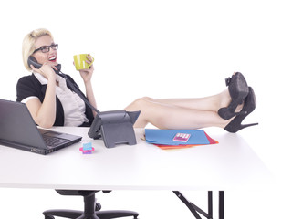 female office clerk talking on telephone while holding a mug