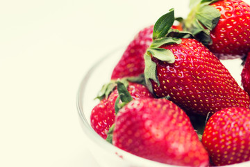close up of ripe red strawberries over white