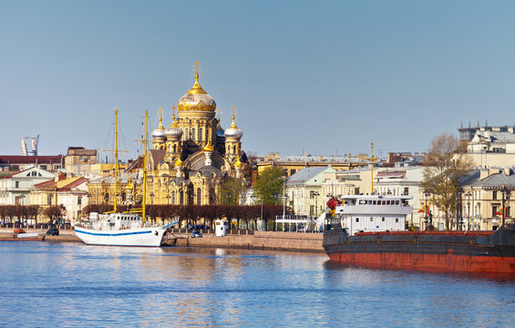 St. Petersburg. View from the Neva River on golden domes of the Cathedral of the Assumption of the Blessed Virgin Mary and Lieutenant Schmidt Embankment in spring