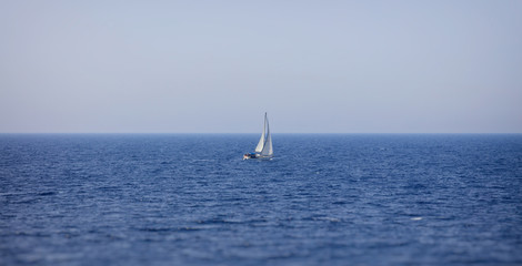 Lonely yacht sailing in sea