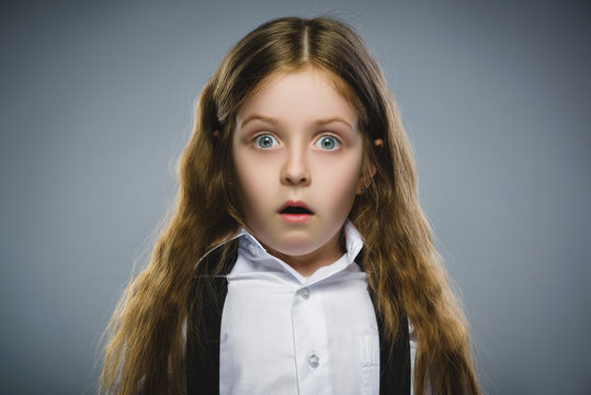 Closeup Portrait of wondering girl going surprise on gray background