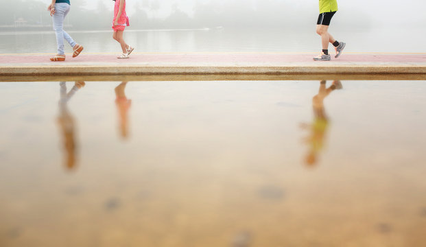 Happy family in the morning with misty and reflection on the water,blurry and color toned. - Powered by Adobe