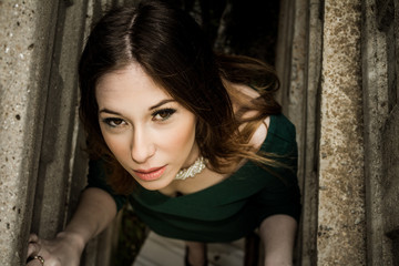 Fototapeta premium Beautiful brunette woman posing outdoor in abandoned industrial