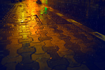 Rain drops on sidewalk,Rainy night in the city.