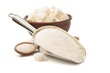 granulated sugar in scoop on white