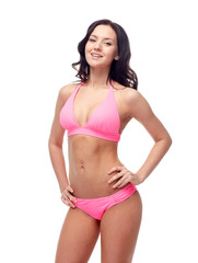 Fototapeta premium happy young woman in pink bikini swimsuit