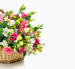 Obraz na płótnie Canvas Beautiful bouquet of bright flowers in basket . Isolated on whit