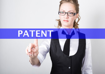 patent written on a virtual screen. Internet technologies in business and tourism. woman in business suit and tie, presses a finger on a virtual screen