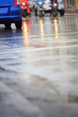 Wet road and rainy day in the city.Blurry soft focus background.