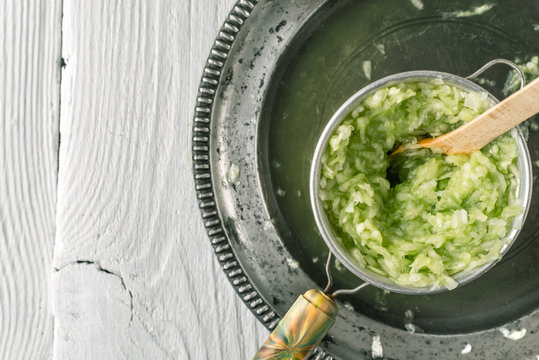 Pressing grated cucumbers in the  strainer top view