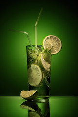 Fresh Mojito cocktail in a green background