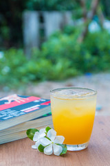 Glass of juice and books on the wooden table