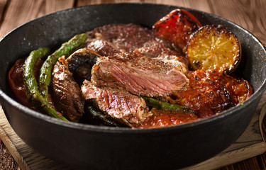 Beef Steak on Cast Iron Pan with grilled vegetables
