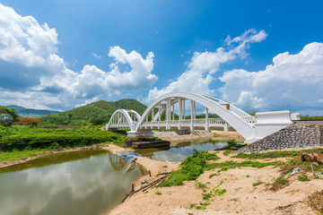 Old white railway bridge constructed against blue sky at Lamphun