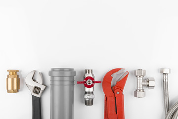 plumbing tools and equipment on white with copy space