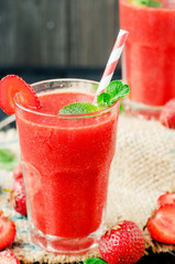 
Summer refreshing healthy drink , strawberry smoothie or fresh  with mint on a wooden background