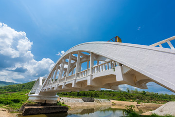 Old white railway bridge constructed against blue sky at Lamphun