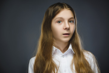 Closeup Portrait of happy girl going surprise isolated on gray background