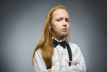 Portrait of offense girl isolated on gray background. Negative human emotion, facial expression....
