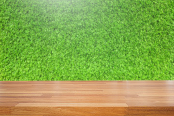 Empty wooden table and blurred green background