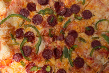 Delicious chorizo and pepper pizza, on the chopping board