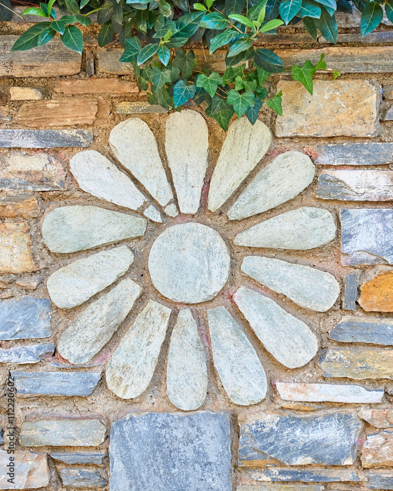 Wall mural stone flower decoration on granite wall