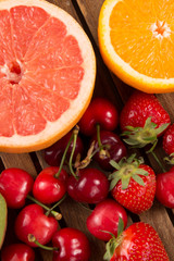 Fresh fruits on color on wooden background