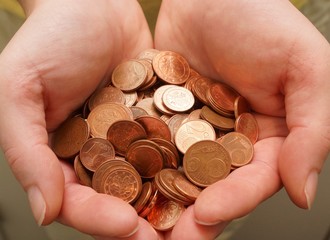 Many euro cent coins in woman hand