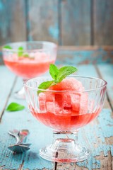 red berry sorbet with mint in a glass