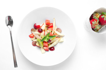 Fruit salad on a white background with berry