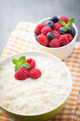 Oatmeal porridge in bowl with berries raspberries and blackberri