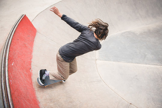 Skate boarder doing tricks at skate park