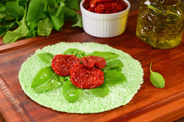 Sun dried and rocket salad on green tapioca